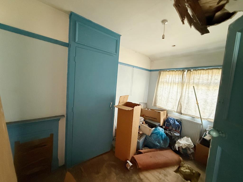 Lot: 47 - EXTENDED END-TERRACE HOUSE FOR IMPROVEMENT - Bedroom 2 with fireplace and window to the rear